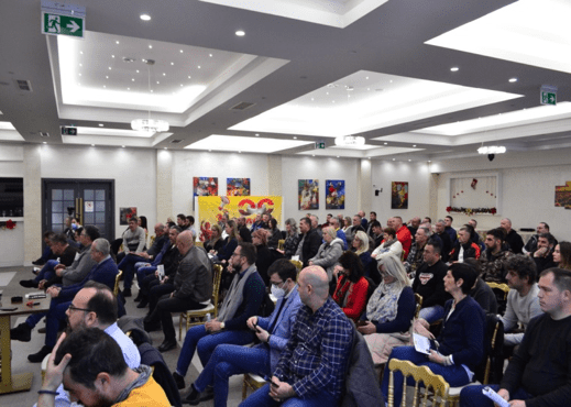Публика седи у сали на предавању или састанку